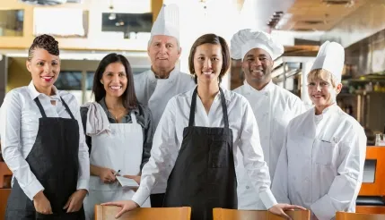 Restaurant staff and chefs using a laundry service app to maintain clean uniforms, aprons, and workplace hygiene efficiently.