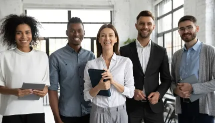 Corporate professionals in an office environment benefiting from a laundry app for employee uniform care and laundry delivery services.